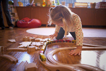 Little girl playing with train