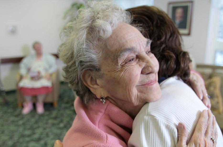 Senior_Woman_Client_Hugging_Volunteers_of_America_Employee.jpg