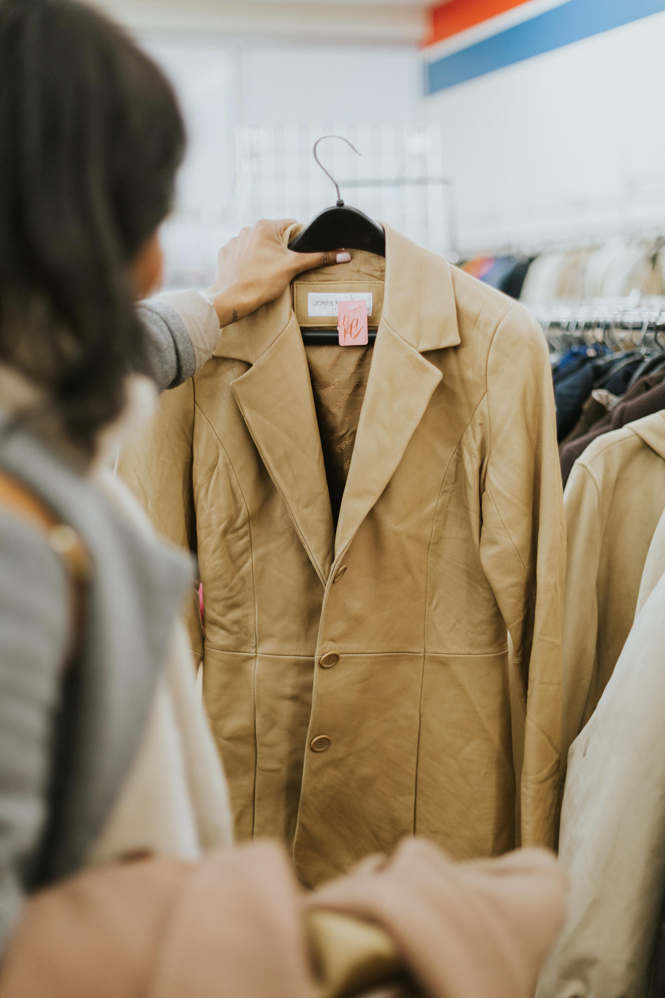 searching for the perfect jacket in thrift store