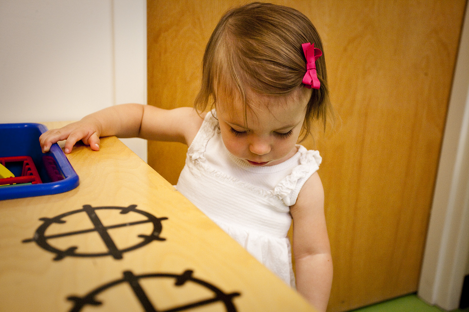 Little girl playing at toy stove